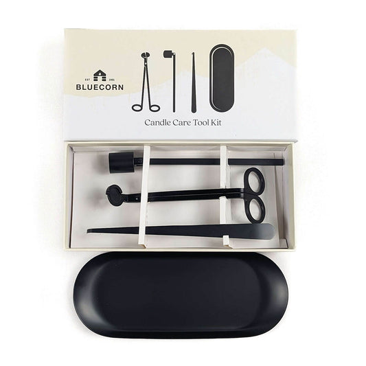 Bluecorn Candle Care Tool Kit shown open with its box lid above, containing black metal tools, with a black oval case placed in front on a white background.