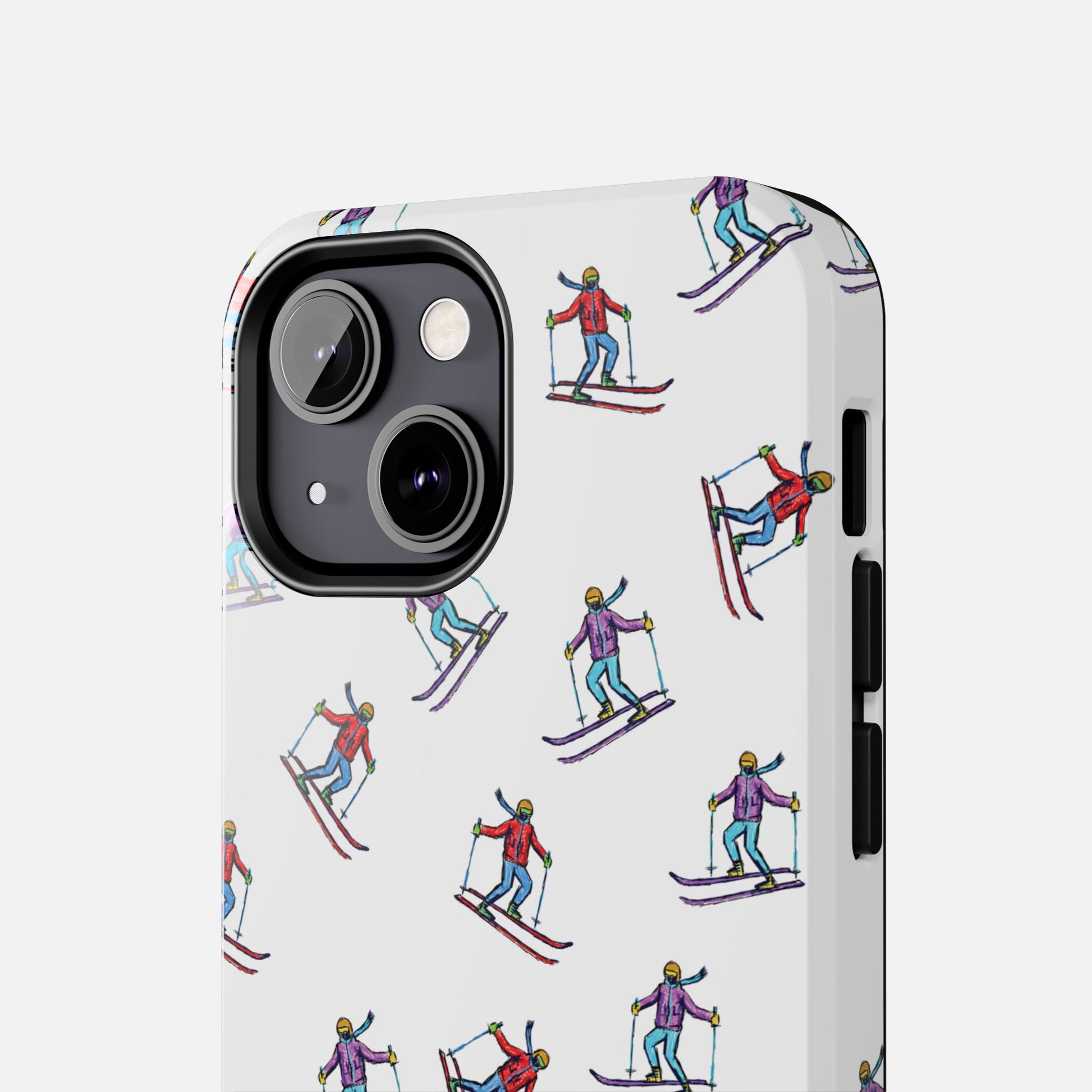 Close-up of the skier pattern on the phone case, showcasing detailed illustrations of skiers in motion.