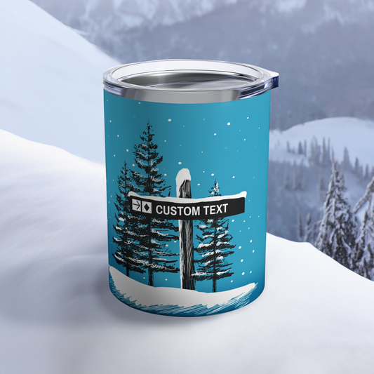 A Custom Ski Trail Sign Tumbler resting on a snowy surface, showcasing a personalized ski trail design. Perfect for keeping beverages hot or cold during ski adventures.