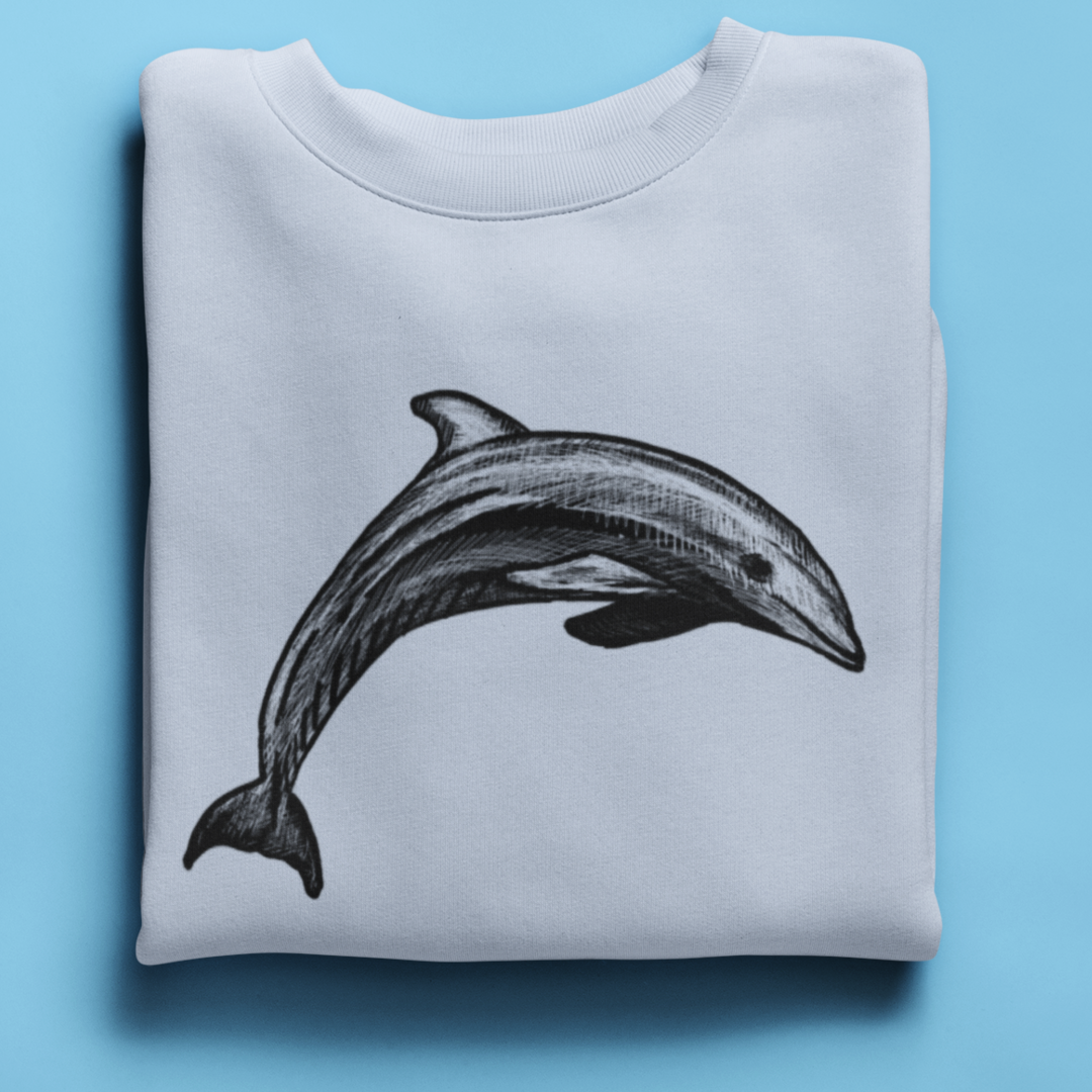 Close-up of minimalist dolphin illustration on sweatshirt fabric, showcasing the fine pen-and-ink detailing and ocean-inspired artwork.