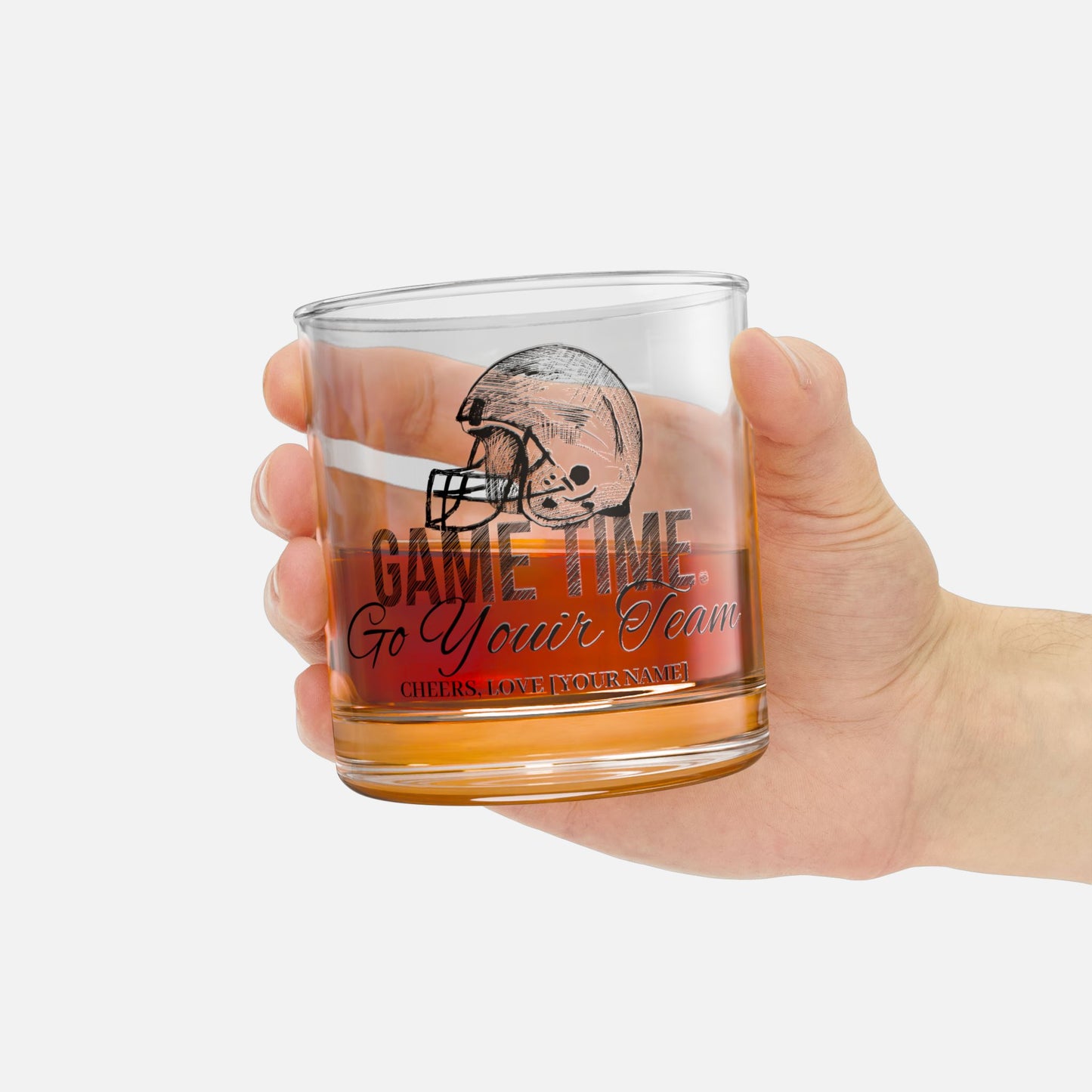 10oz personalized whiskey glass on in a hand with scotch inside, featuring a detailed football helmet design and custom text. Perfect gift for football fans.