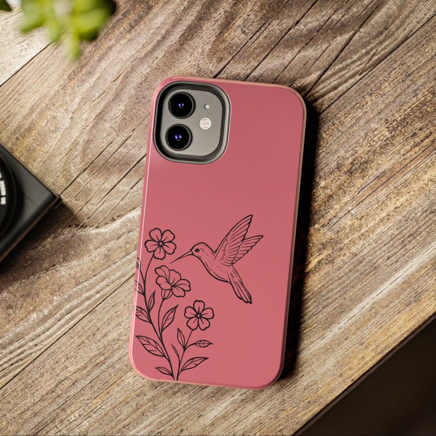 Hummingbird & Flowers Phone Case styled on wooden table with flowers, showcasing artistic and nature-inspired design.