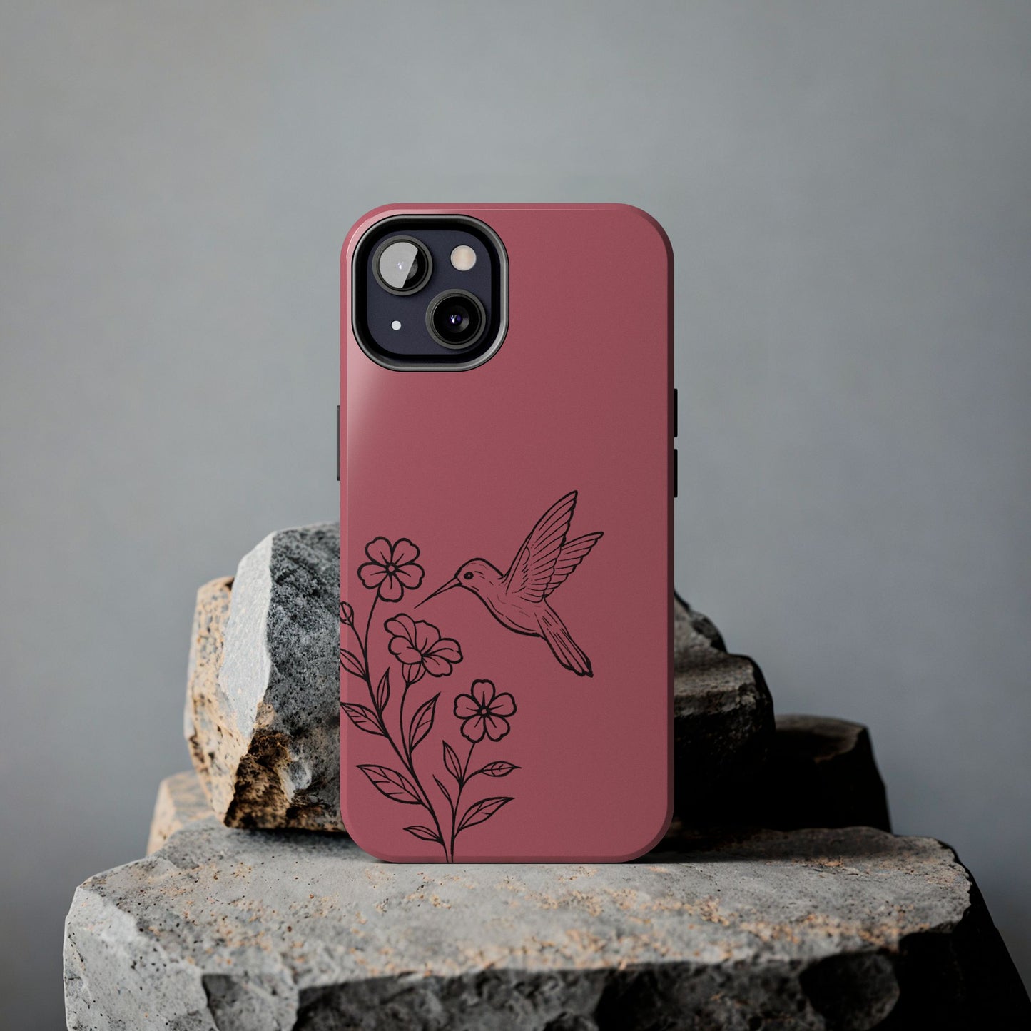 Hummingbird & Flowers Phone Case styled on rock, showcasing artistic and nature-inspired design.