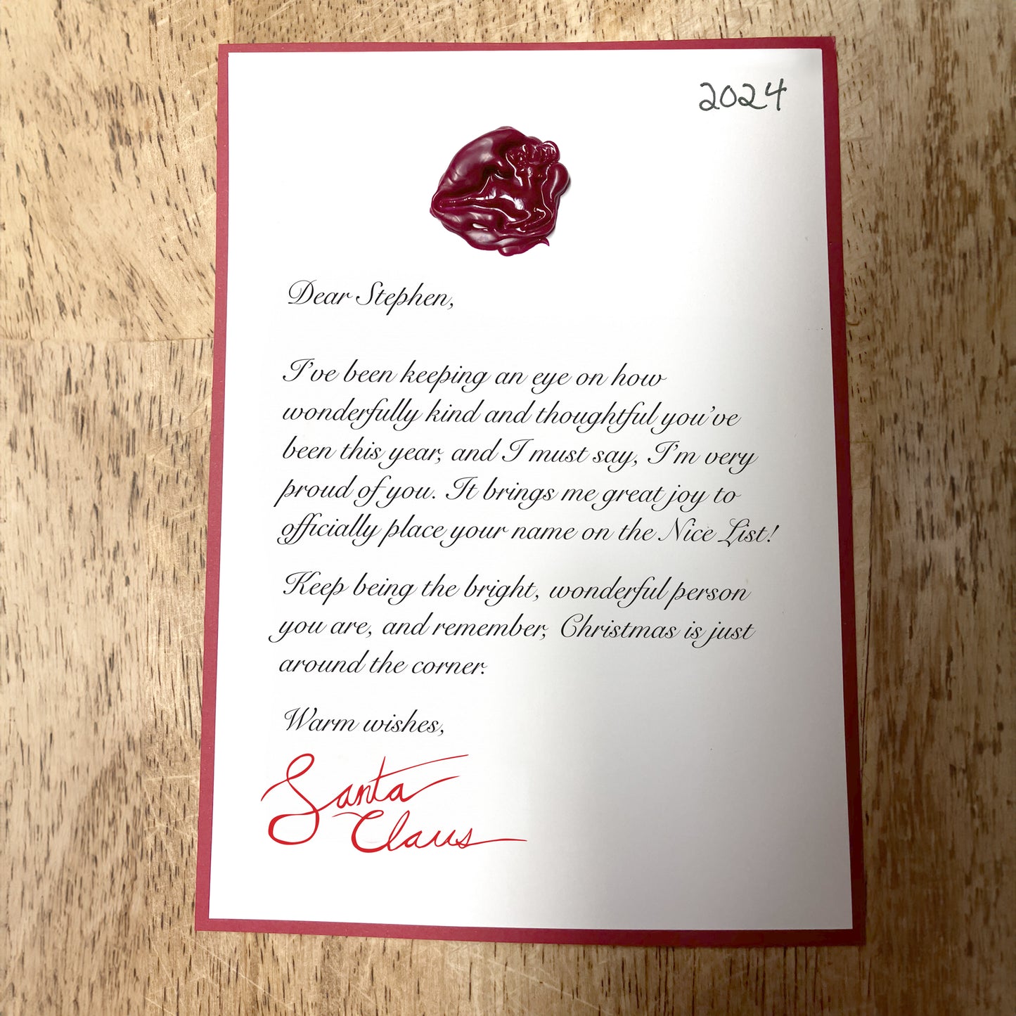 Close-up of a personalized letter from Santa, featuring festive details like a wax seal and custom message, showcasing the unique and heartfelt design of the holiday letter.