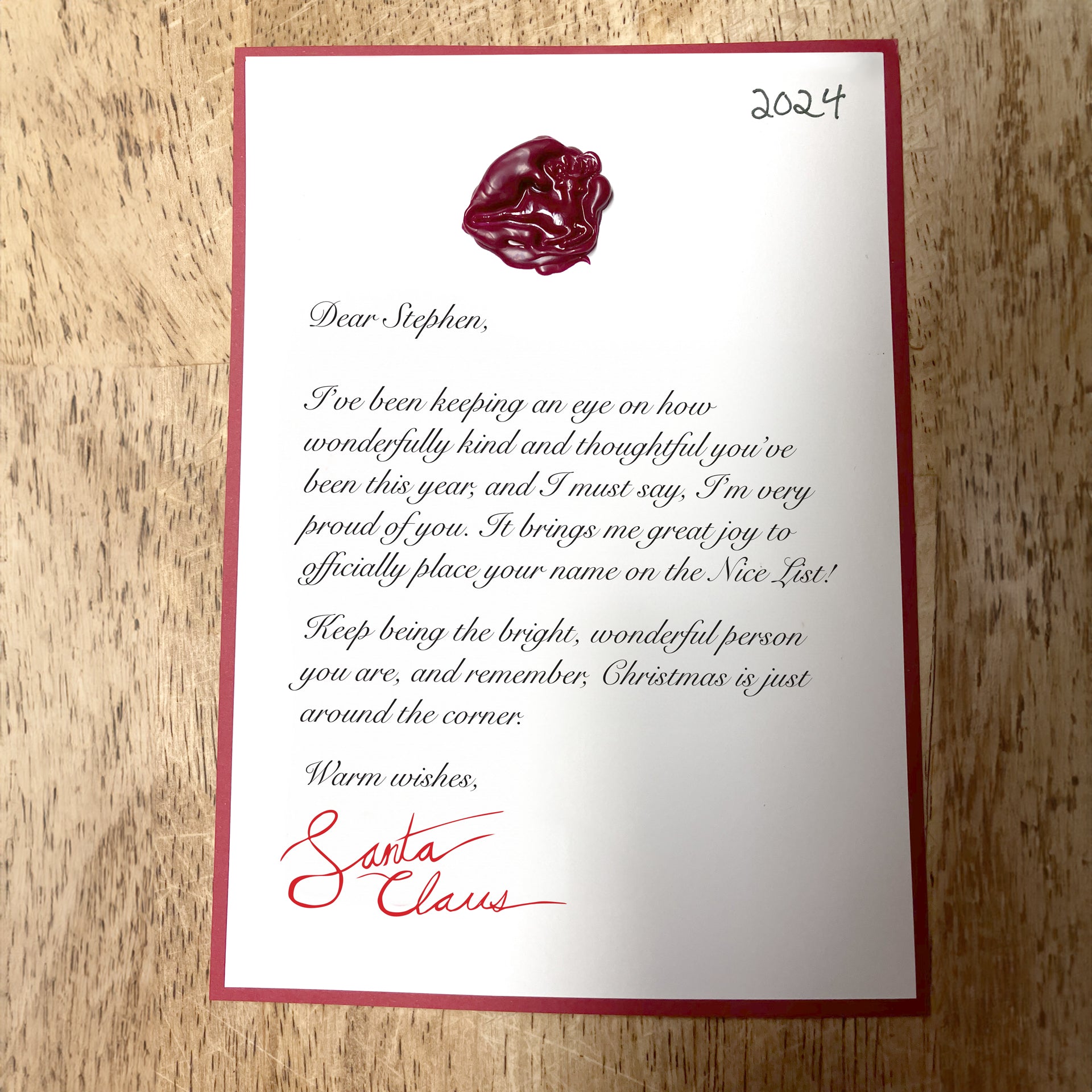 Close-up of a personalized letter from Santa, featuring festive details like a wax seal and custom message, showcasing the unique and heartfelt design of the holiday letter.