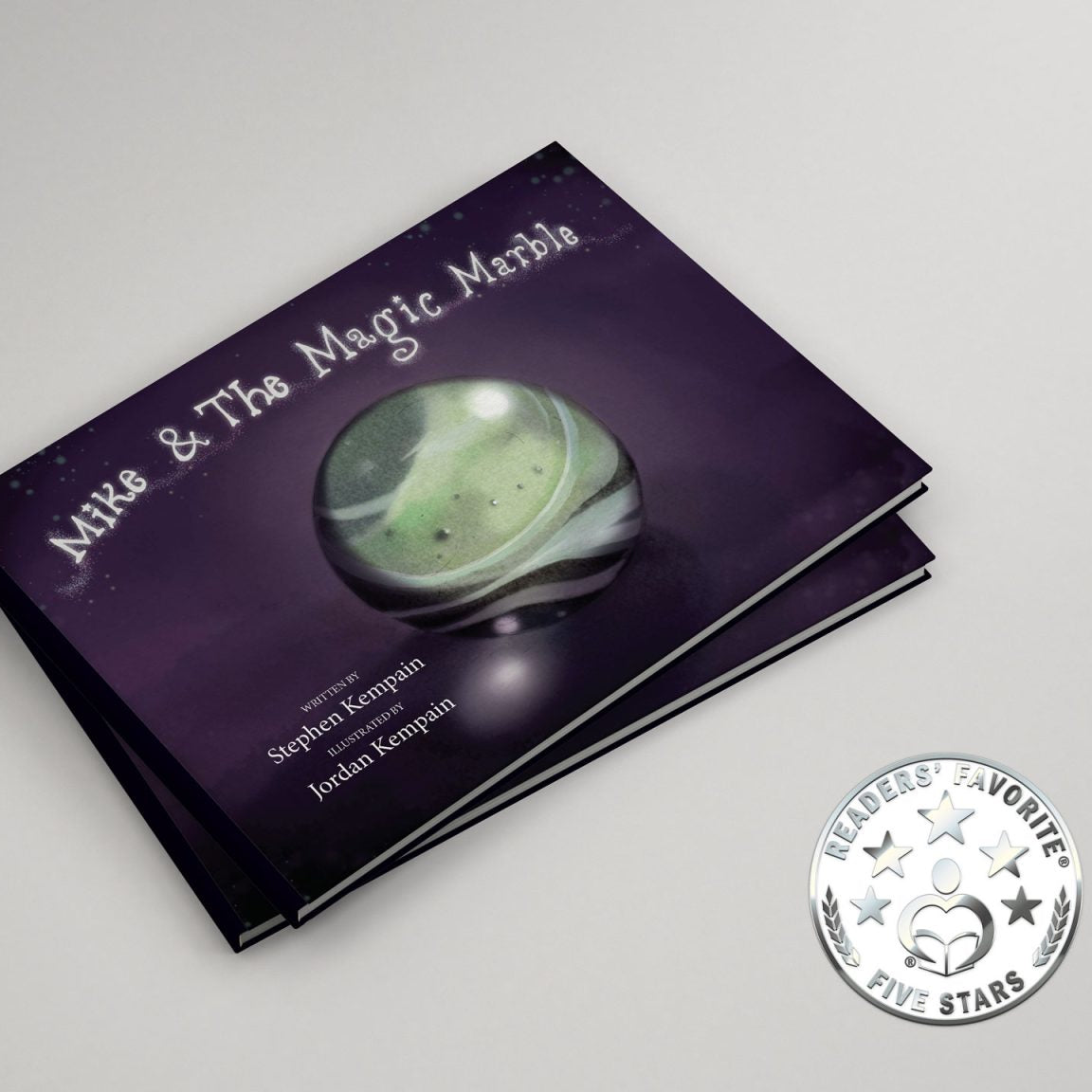 Book titled 'Mike & The Magic Marble' with a green marble on a purple cover, on a white background.