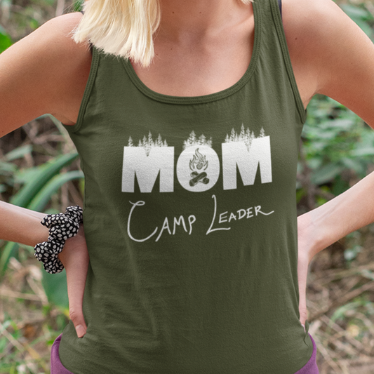 A military green racerback tank top on model showcasing a design that says MOM Camp Leader with illustrated forest trees and campfire within the O of MOM.
