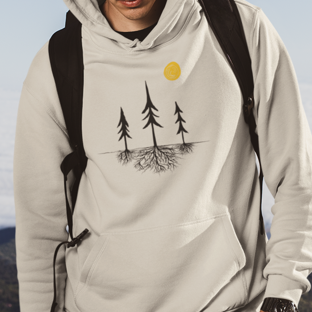 Model wearing Sand-colored nature-inspired hoodie featuring a tree silhouette with exposed roots and a sun design. Unisex pullover sweatshirt displayed on a white background, showcasing minimalist outdoor apparel for forest lovers and hikers.