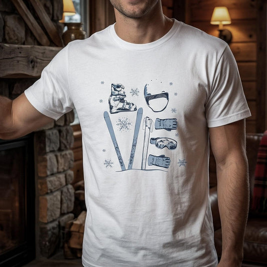 A white crew neck t-shirt with a graphic that includes illustrated ski boots, a helmet, skis, gloves, goggles, and poles that form letters LOVE worn by a model in a lodge setting.
