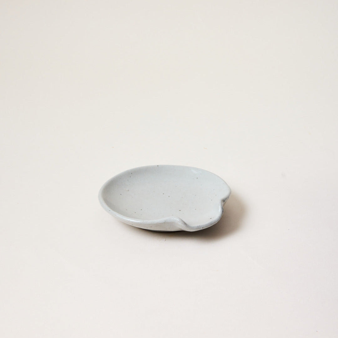 Small spoon rest ceramic plate on a light beige background made by Farmhouse Pottery, Vermont
