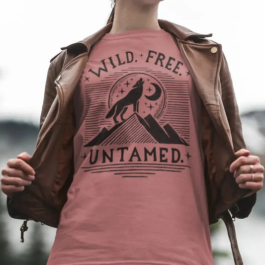 The Untamed Wolf 100 percent cotton Women’s T-Shirt worn by a female model featuring artwork illustrated by Jordan Kempain, available in sizes Small through 5XL.