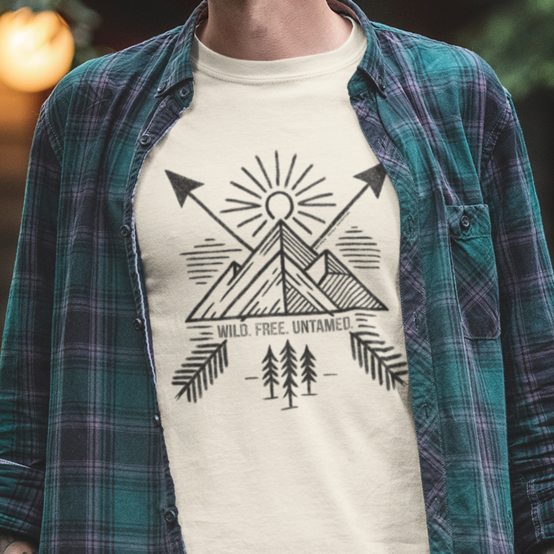 Model wearing Wild. Free. Untamed. Adventure-Inspired Unisex T-Shirt, featuring bold typography, perfect for adventurers, explorers, and outdoor enthusiasts.