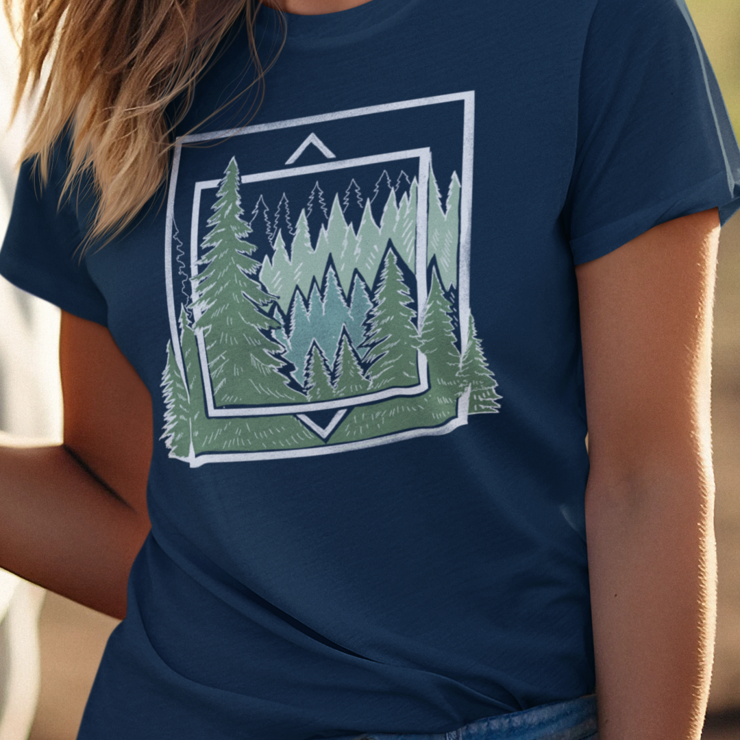 Ancient Pine Tree Women’s T-Shirt worn by a model, featuring a geometric forest design inspired by nature and outdoor adventures.