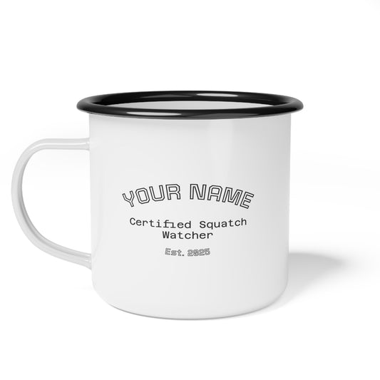 A camping mug with black rim and illustrated bigfoot graphic on white background featuring custom text for name and text "certified squach watcher, est. 2025".