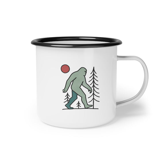A camping mug with black rim and illustrated bigfoot graphic on white background.
