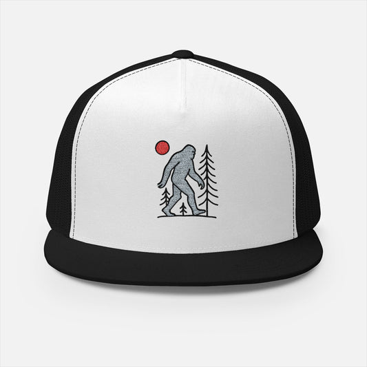 Front cap design of embroidered trucker cap featuring Sasquatch walking in the woods.