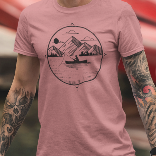 Model wearing Canoe Fishing T-Shirt, featuring a geometric illustration of a fisherman in a canoe with mountains in the background, perfect for anglers and outdoor adventurers.