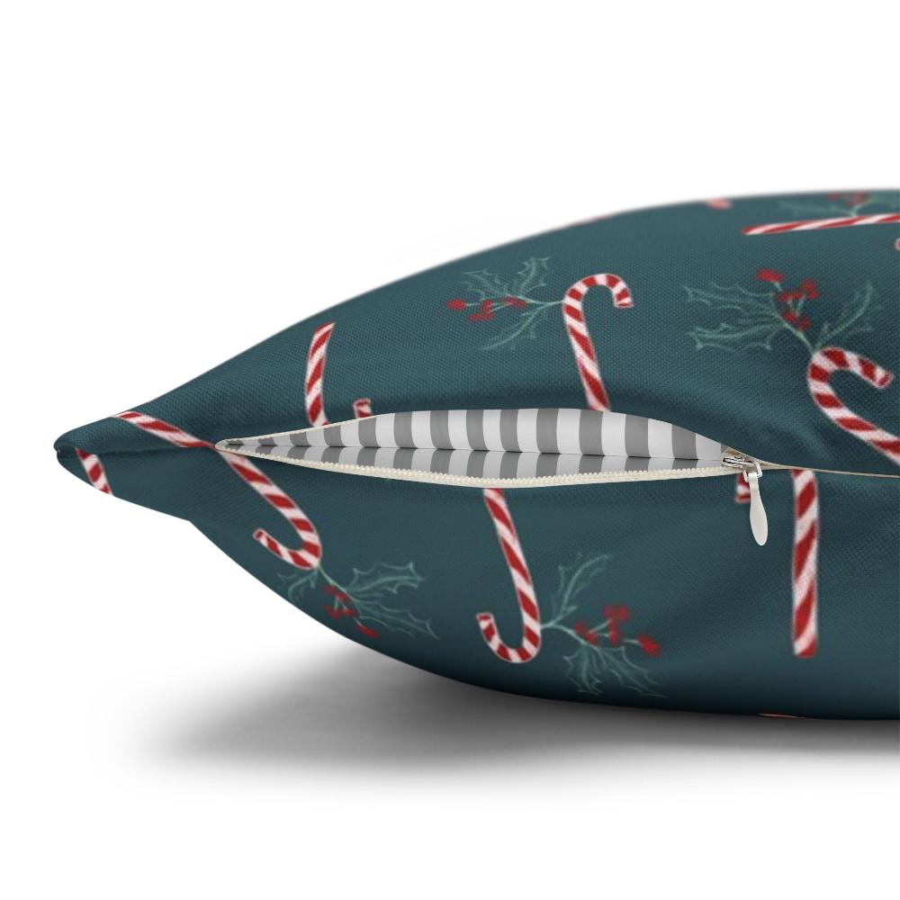Close-up view of the zipper on a square pillow case featuring a candy cane and holly pattern, showcasing the quality and design details of the festive cover.