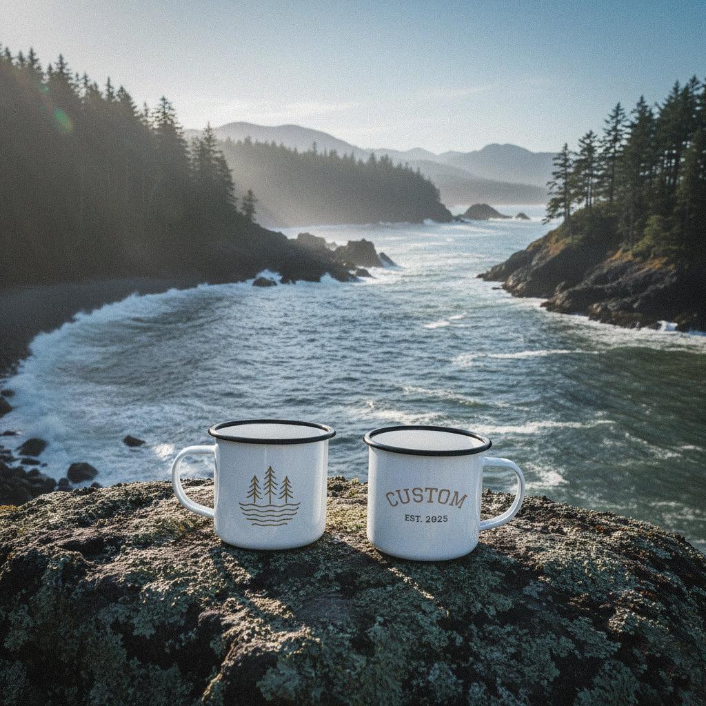 Two personalized waves and timber line mugs on a rocky point overlooking a choppy coastal bay with pine trees.