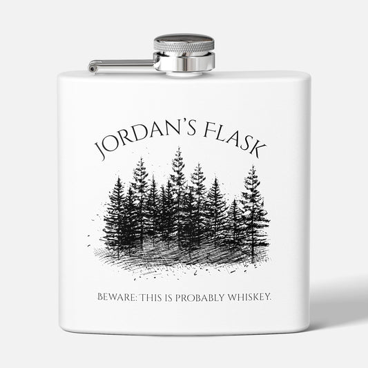 Front view of custom stainless steel flask with forest graphic and personalized text on white background