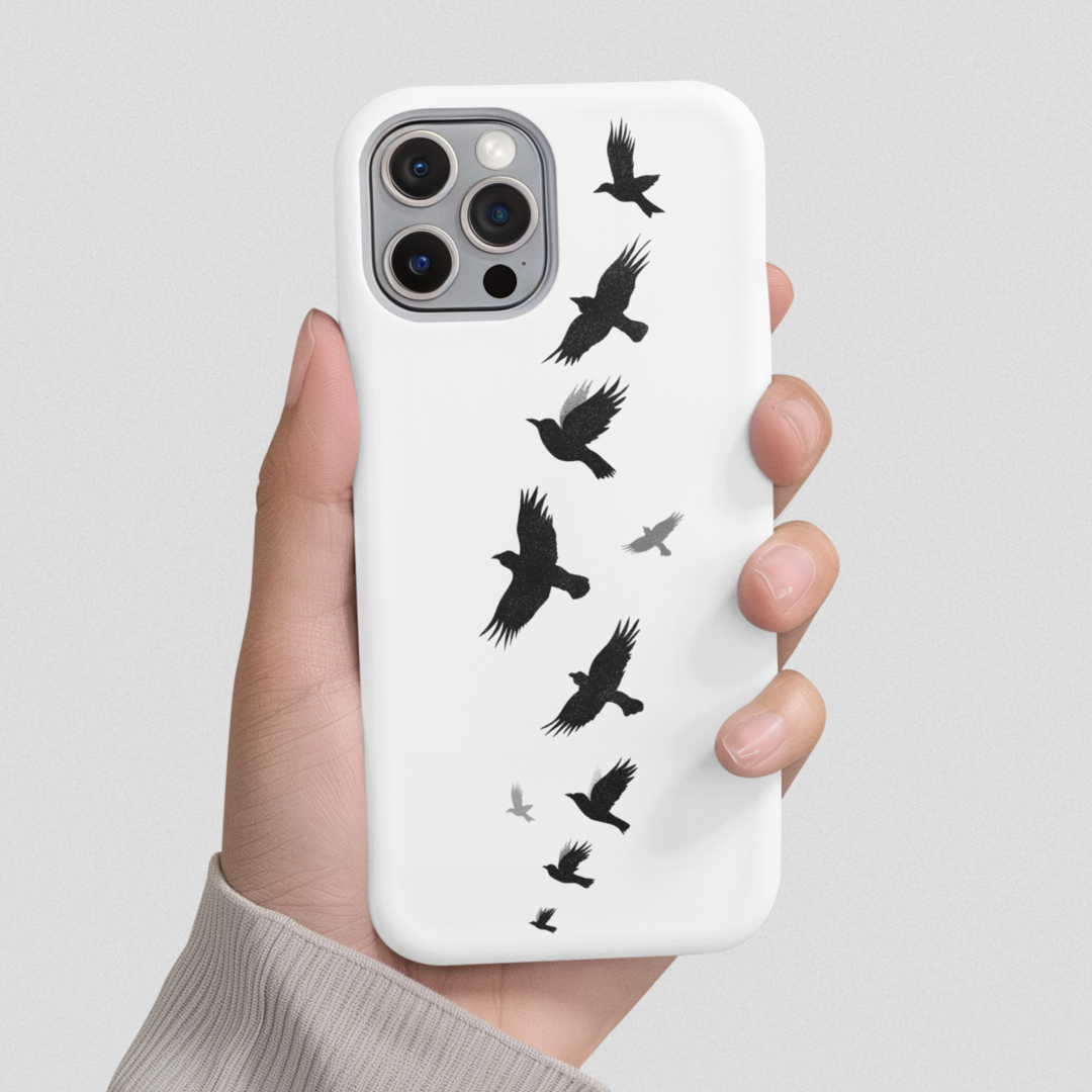 Flying Crows Silhouette Phone Case shown hand-held against a gray background, highlighting its bold black bird design and sleek, minimalist aesthetic.