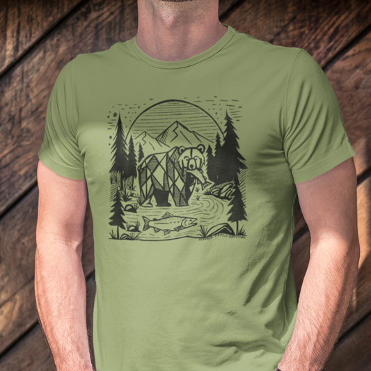 Model wearing Geometric Bear & Salmon T-Shirt, featuring a bold geometric bear catching a salmon with a mountain river and pine trees, perfect for outdoor and wildlife enthusiasts.