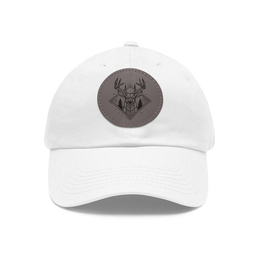 Front view in white option of the Geometric Buck Dad Hat on a white background, showcasing a vegan leather patch with stylized buck and pine tree design on soft chino twill fabric.