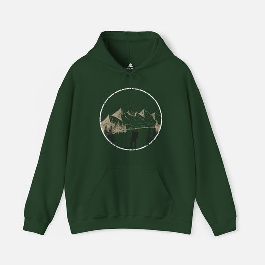 Green color Hiking Graphic Hoodie displayed on white background, featuring a stunning hand-drawn illustration of majestic mountains and a compass rising in the sky. Whether you're exploring the trails or cozying up by the fire, this hoodie is the perfect companion for outdoor enthusiasts.