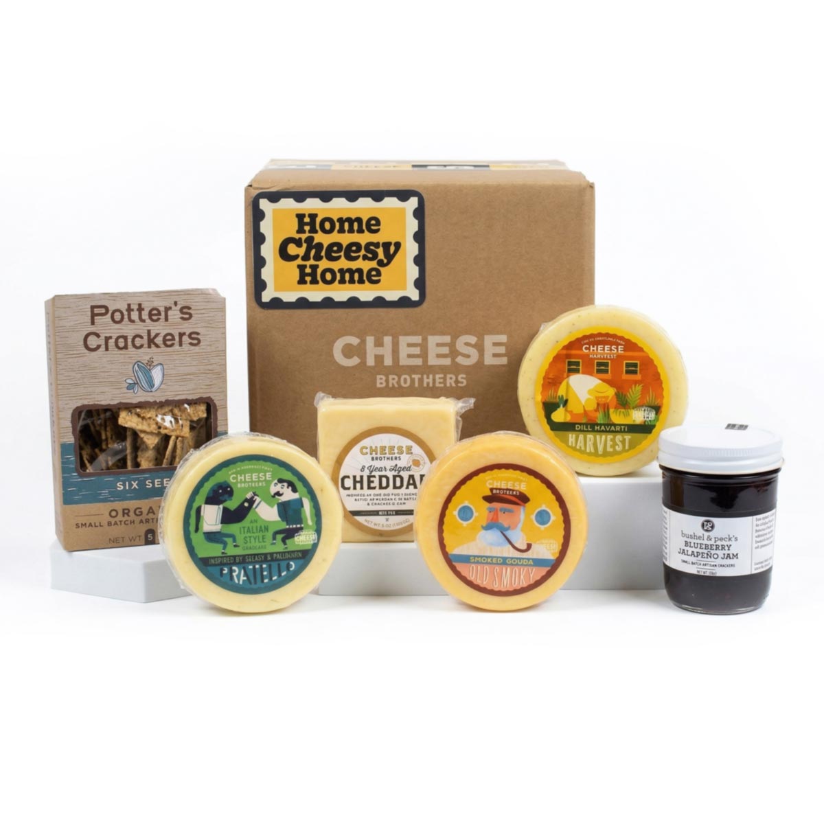 A Housewarming Gift Pack featuring Cheese Brothers 8-Year Aged Cheddar and Artisan Dill Havarti curated by Kempain Family Outfitters.