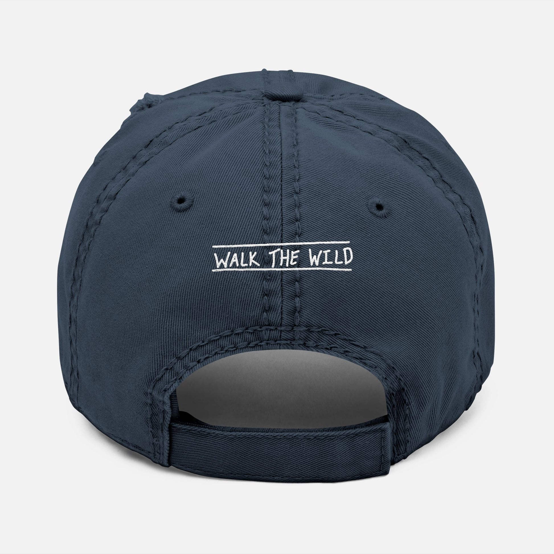 Back view of navy dad hat with adjustable strap and “Walk the Wild” embroidered in a hand-drawn font, celebrating the bond of the hunt.