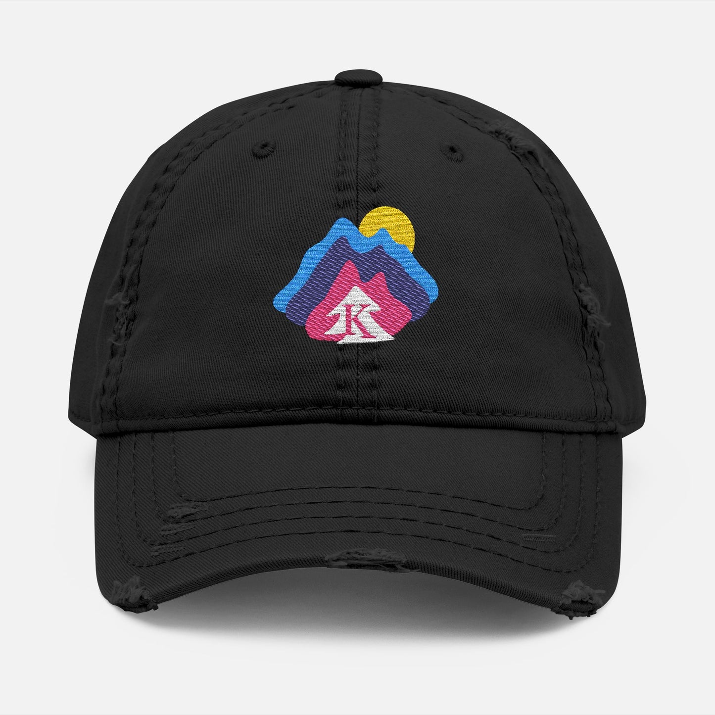 Front view of black distressed dad hat on white background, featuring an embroidered mountain and sun design with the Kempain Family Outfitters tree + K emblem.