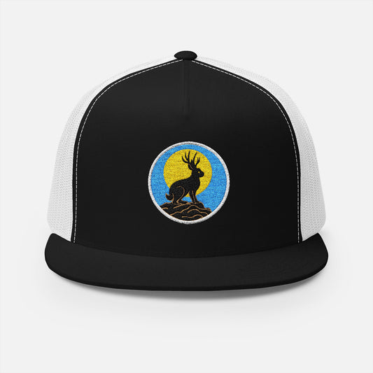 Front view of black/white trucker cap featuring embroidered jackalope silhouette and moonrise design in white thread.