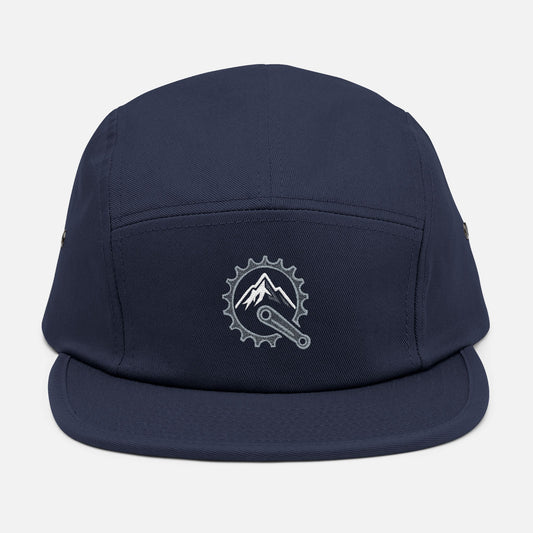 Front view of navy 5-panel cap featuring embroidered mountain and bike crank design in metallic silver and white.