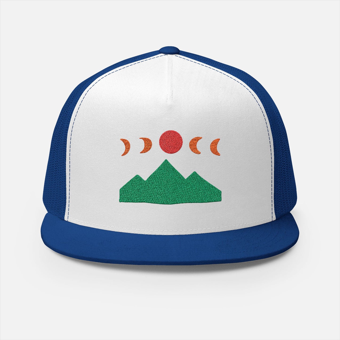 Front of Mountain Ridge and Moon Phase blue trucker cap showing the embroidery design of mountain ridges and moon phases in a minimalist style by Kempain Family Outfitters.