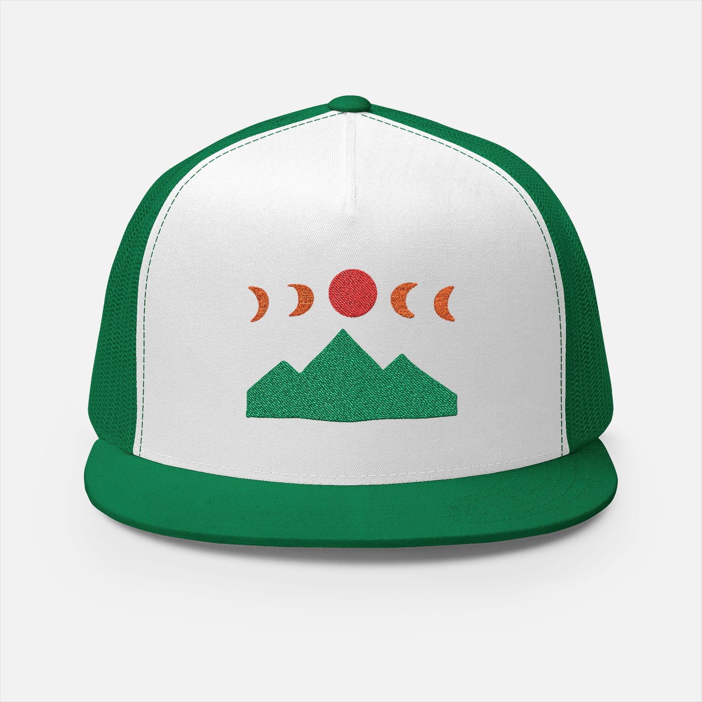 Front of Mountain Ridge and Moon Phase green trucker cap showing the embroidery design of mountain ridges and moon phases in a minimalist style by Kempain Family Outfitters.