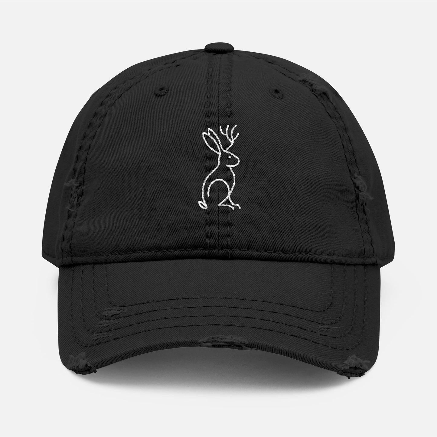 Front view of black Mythborn Jackalope Dad Hat with Picasso-inspired line art of a jackalope, shown on white background.