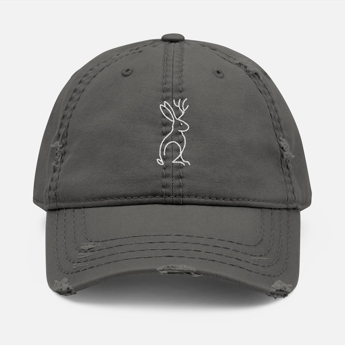 Front view of charcoal grey Mythborn Jackalope Dad Hat with Picasso-inspired line art of a jackalope, shown on white background.