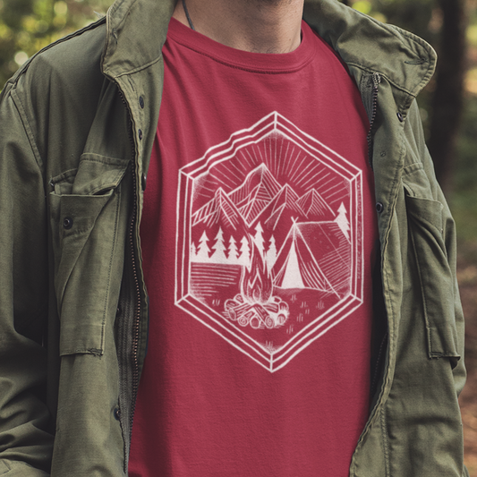 Nature’s Refuge Geometric Camping T-Shirt worn by a model, featuring a cozy tent, glowing campfire, and pine trees—perfect for outdoor adventurers and campers.