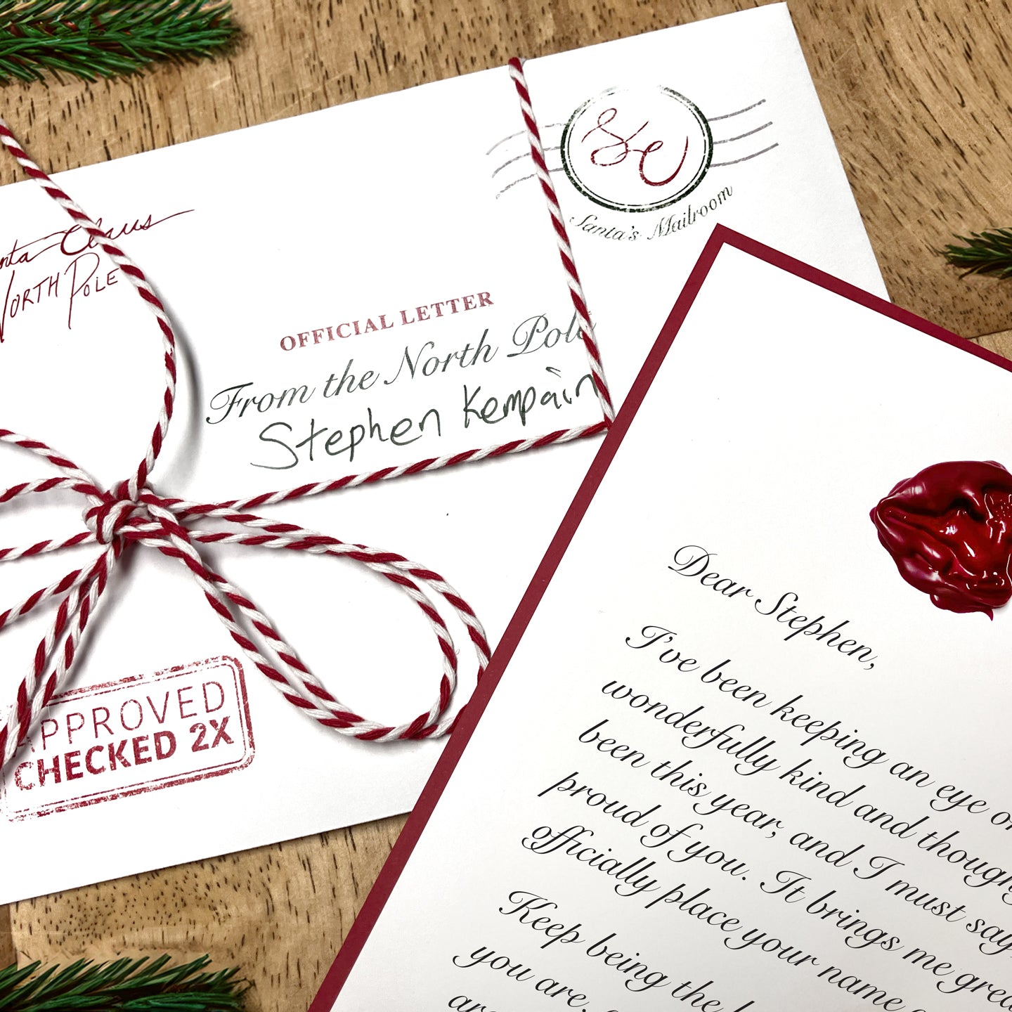 Personalized letter from Santa, placed on a table with a detailed wax seal and envelope, showcasing the unique and custom nature of the holiday letter.