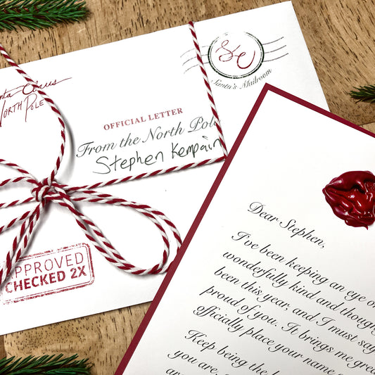 Personalized letter from Santa, placed on a table with a detailed wax seal and envelope, showcasing the unique and custom nature of the holiday letter.