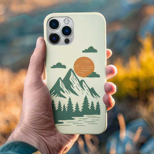 Pine & Mountain Sunrise Phone Case held in hand, highlighting mountain sunrise illustration and nature-inspired color palette.