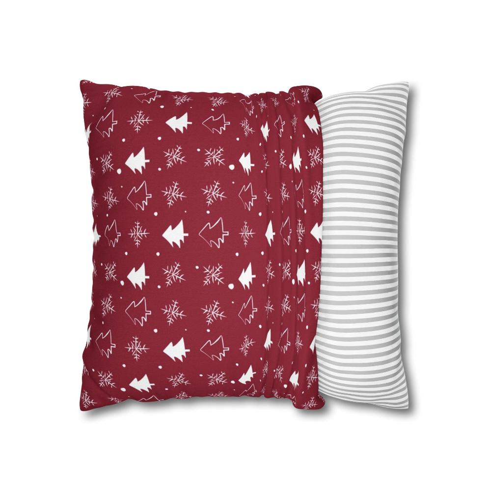 Red pillow case featuring a winter snowflake and tree pattern, partially fitted over a pillow, showing how it fits and highlighting the festive winter design.