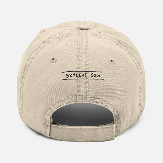 Back view of dad hat with adjustable strap and “Skyline Soul” embroidered in hand-drawn font, inspired by mountain adventures.