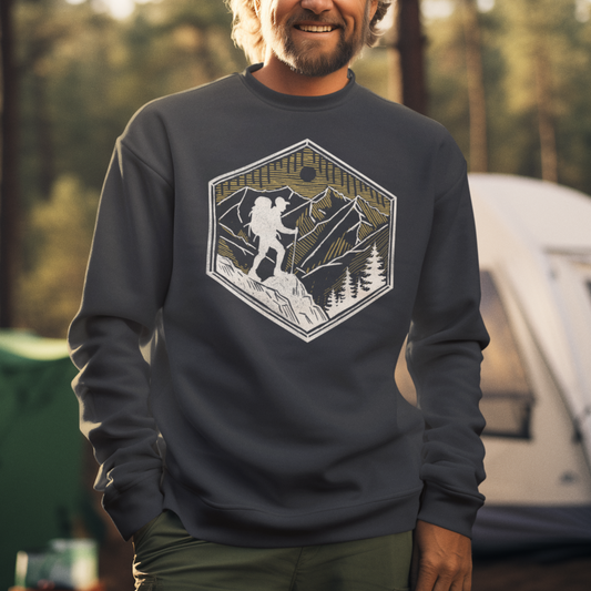 Skyline Trek Sweatshirt worn by a model, featuring a minimalist geometric hiker silhouette against a mountain skyline at sunset—perfect for adventurers and outdoor lovers.