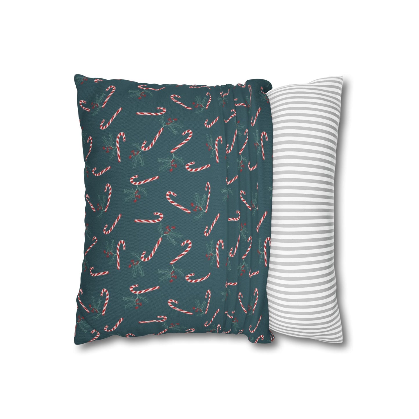Square pillow case with a candy cane and holly pattern, partially pulled over a throw pillow, showing how it fits and highlighting the festive holiday design.