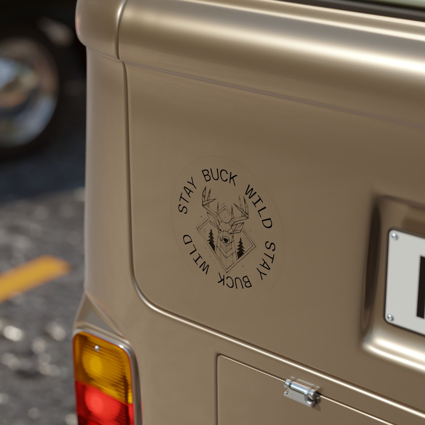 Beige vehicle with a logo and text on the back featuring a Kempain Family Outfitters "Stay Buck Wild" sticker with Whitetail Deer and forest geometric design.