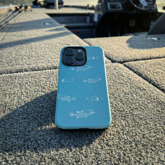Blue phone case with largemouth bass pattern illustrations on aqua color background displayed on a bass boat carpeted deck.