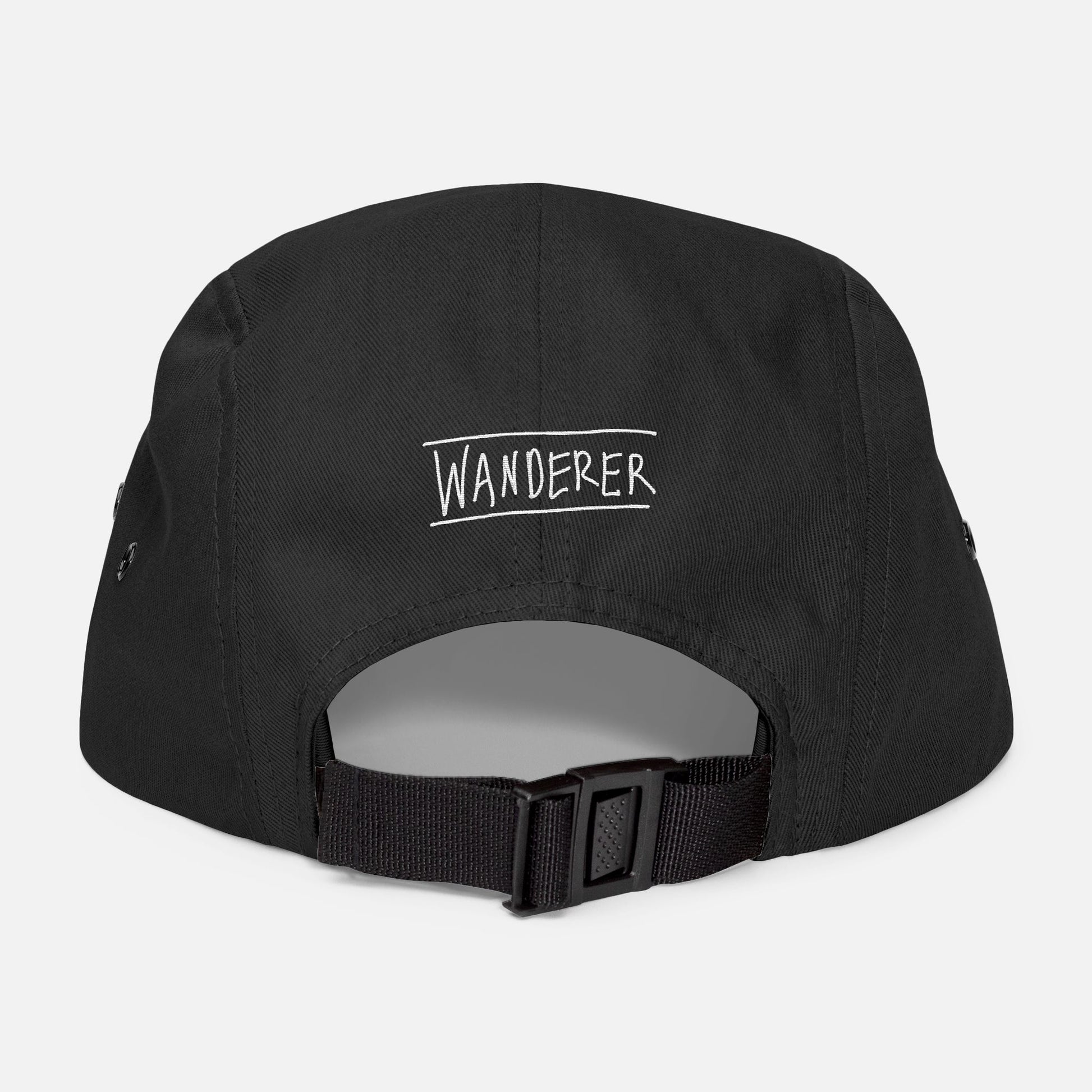 Back view of black low-profile cap with adjustable strap and “wanderer” embroidered in casual handwritten script.