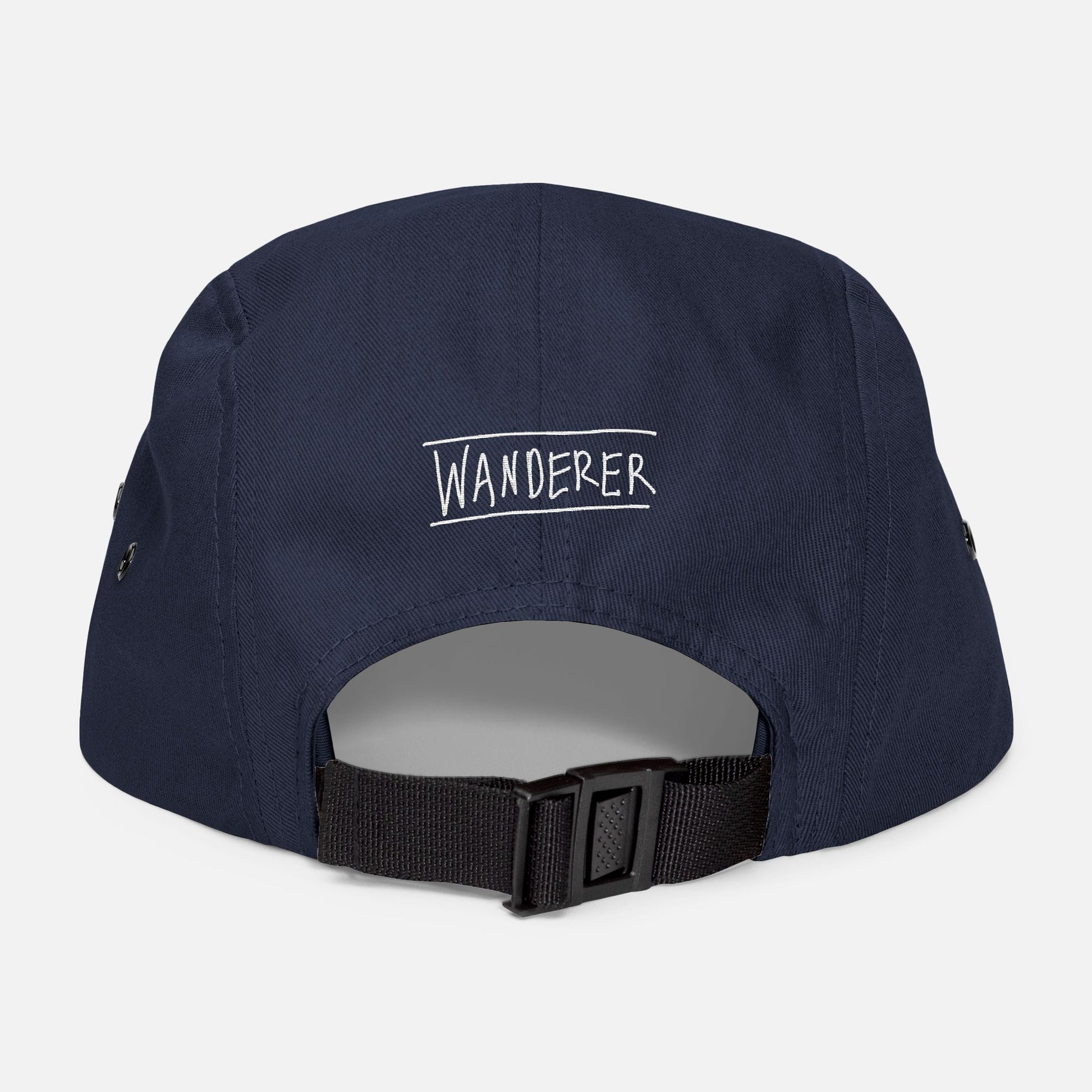Back view of navy low-profile cap with adjustable strap and “wanderer” embroidered in casual handwritten script.