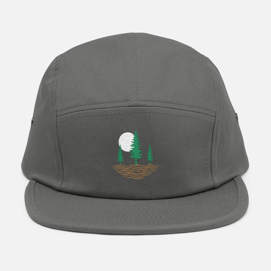 Front view of grey low-profile cap with embroidered design of three pine trees, a rising sun, and ripple lines symbolizing the earth.